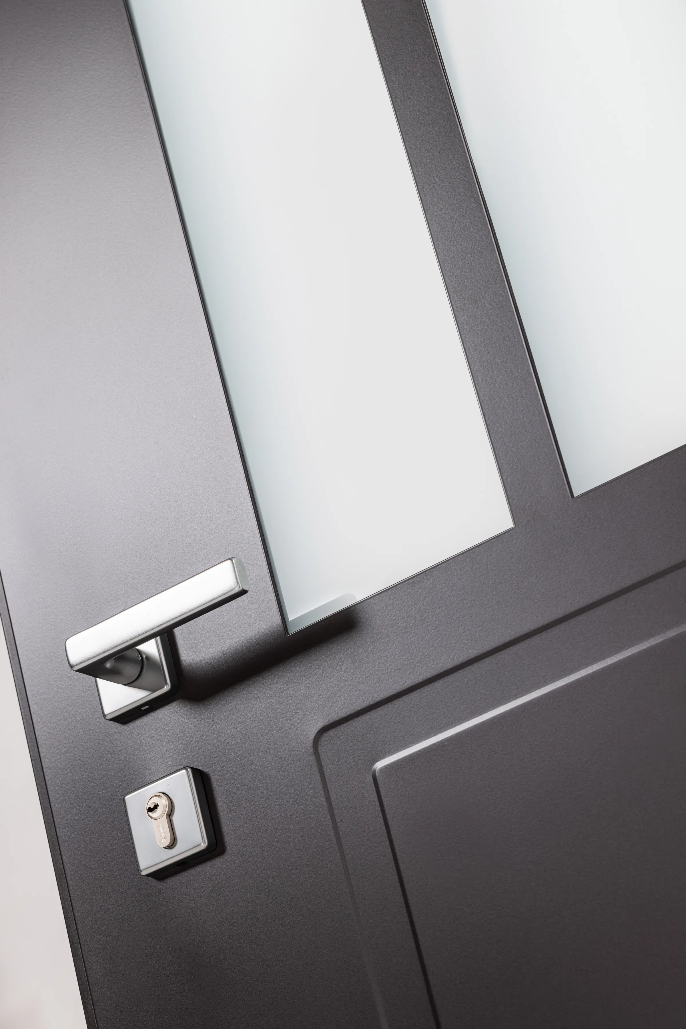 Détail de la poignée Quartz en inox brossé : béquille et rosaces carrées